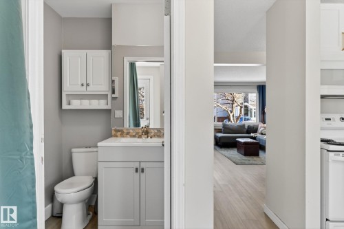 The bathroom features a toilet, a vanity with cabinet storage, and an overhead medicine cabinet - 1873 151 Avenue, Edmonton, AB - Indoor Photo Showing Bathroom