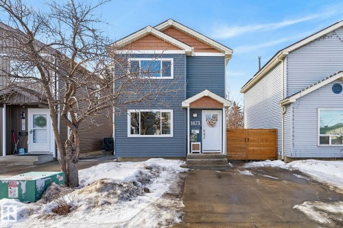 The property features blue siding with brown trim accents and a white front door - 1873 151 Avenue, Edmonton, AB - Outdoor