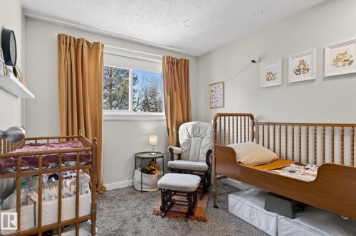 This room features a window providing natural light, carpeted flooring, and light-colored walls - 1873 151 Avenue, Edmonton, AB - Indoor