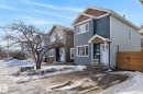 The property features a two-story exterior with blue and light grey siding, complemented by brown accents on the gables - 1873 151 Avenue, Edmonton, AB  - Outdoor With Facade 