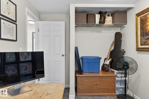 This room features light gray walls, a white paneled door, and a built-in wire shelf - 1873 151 Avenue, Edmonton, AB - Indoor