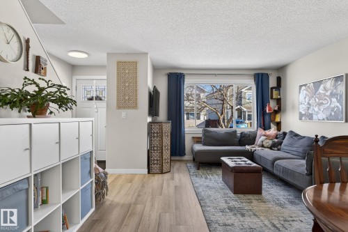 The living area features light-toned flooring, a window offering views of the neighborhood, and a ceiling with recessed lighting - 1873 151 Avenue, Edmonton, AB - Indoor Photo Showing Living Room