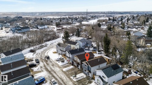 This property offers an elevated view of the surrounding residential landscape, featuring a paved street and numerous houses with varied rooflines - 1873 151 Avenue, Edmonton, AB - Outdoor With View