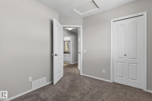 This room features light grey walls and plush grey carpeting - 30 450 Hyndman Crescent, Edmonton, AB - Indoor