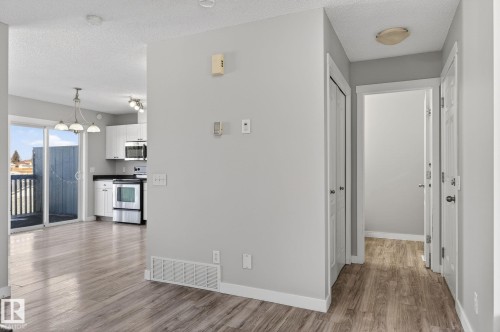 The property features light-colored walls and wood-look flooring throughout - 30 450 Hyndman Crescent, Edmonton, AB - Indoor