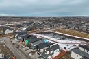 The property is situated within a developing residential community, featuring a clear view of surrounding homes and natural landscapes - 7665 Kimiwan Crescent, Edmonton, AB  - Outdoor With View 