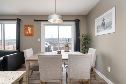 Dining area with wood finished floors and healthy amount of natural light - 1964 Kroetsch Crescent, Edmonton, AB - Indoor Photo Showing Dining Room