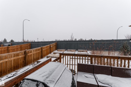 Snow covered deck with a fenced backyard - 1964 Kroetsch Crescent, Edmonton, AB - Outdoor
