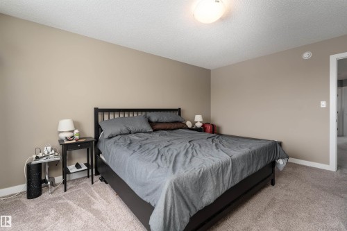 Bedroom with light colored carpet and a textured ceiling - 1964 Kroetsch Crescent, Edmonton, AB - Indoor Photo Showing Bedroom