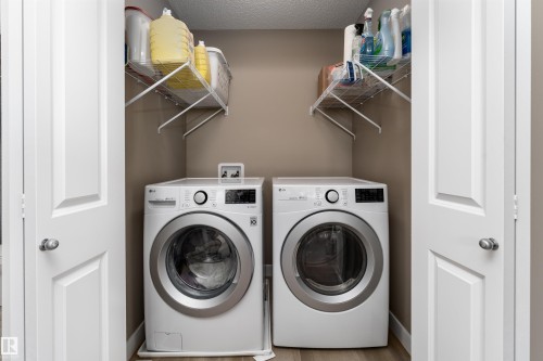Laundry area featuring a textured ceiling and separate washer and dryer - 1964 Kroetsch Crescent, Edmonton, AB - Indoor Photo Showing Laundry Room