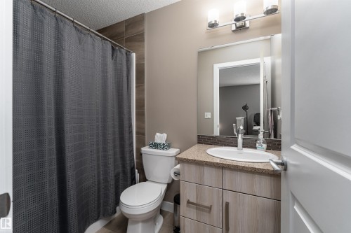 Full bath with vanity, a shower with shower curtain, and a textured ceiling - 1964 Kroetsch Crescent, Edmonton, AB - Indoor Photo Showing Bathroom