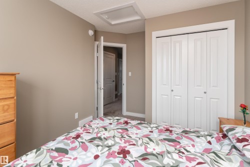 Bedroom featuring a closet and a textured ceiling - 1964 Kroetsch Crescent, Edmonton, AB - Indoor Photo Showing Bedroom
