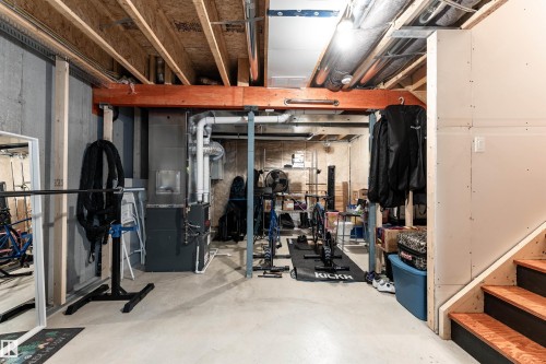 Exercise room featuring concrete floors and heating unit - 1964 Kroetsch Crescent, Edmonton, AB - Indoor Photo Showing Gym Room
