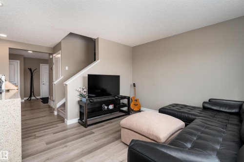Living area with a textured ceiling, light wood-style flooring, and recessed lighting - 1964 Kroetsch Crescent, Edmonton, AB - Indoor