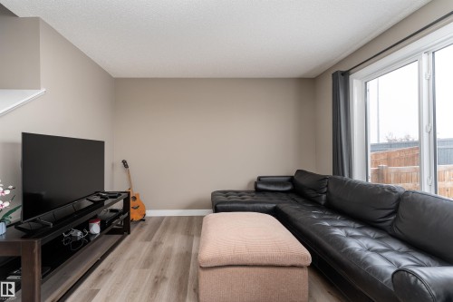 Living area featuring light wood-type flooring and a textured ceiling - 1964 Kroetsch Crescent, Edmonton, AB - Indoor Photo Showing Living Room