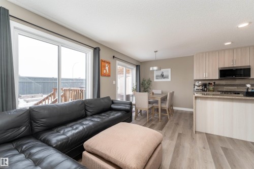 Living area with light wood-type flooring, recessed lighting, and a textured ceiling - 1964 Kroetsch Crescent, Edmonton, AB - Indoor Photo Showing Living Room