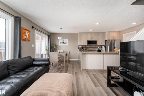 Living area featuring a textured ceiling, light wood-style flooring, and recessed lighting - 1964 Kroetsch Crescent, Edmonton, AB - Indoor