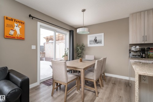 Dining area featuring light wood-type flooring and a textured ceiling - 1964 Kroetsch Crescent, Edmonton, AB - Indoor Photo Showing Dining Room