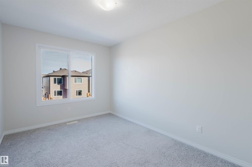 Well-lit room featuring carpeted floors, a window, and light-colored walls - 2082 Price Landing, Edmonton, AB - Indoor Photo Showing Other Room
