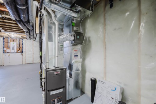 The property includes a furnace system and ductwork, with exposed ceiling joists and insulated walls - 2082 Price Landing, Edmonton, AB - Indoor Photo Showing Basement