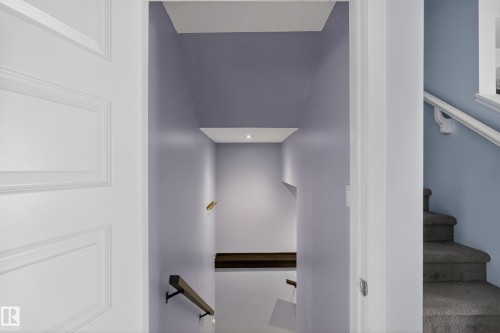Entryway featuring a white paneled door and light purple walls - 1522 Chapman Way, Edmonton, AB - Indoor Photo Showing Other Room