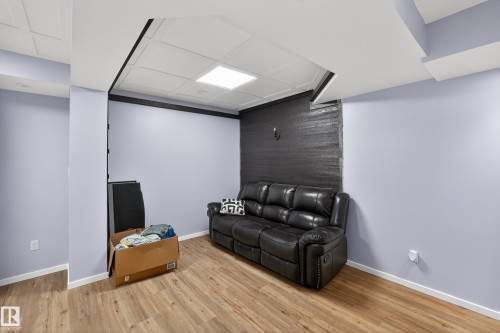 This versatile space features light wood-style flooring, light-colored walls, and a recessed ceiling light - 1522 Chapman Way, Edmonton, AB - Indoor