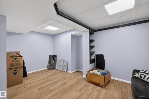 Spacious room featuring light wood-look flooring, light-colored walls, and recessed lighting - 1522 Chapman Way, Edmonton, AB - Indoor