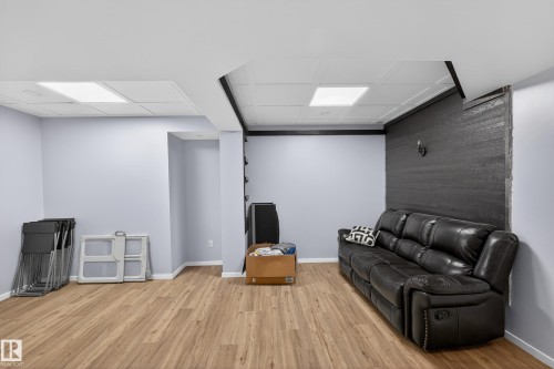 This spacious room features light-colored walls and a drop ceiling with recessed lighting - 1522 Chapman Way, Edmonton, AB - Indoor Photo Showing Basement