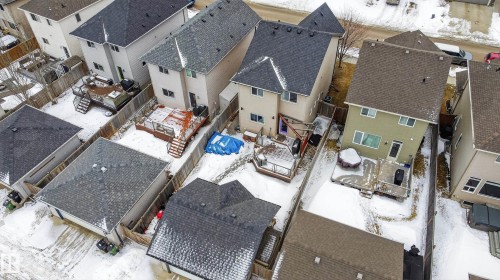 The property features a fenced yard with a deck and a detached garage, offering practical outdoor space - 1522 Chapman Way, Edmonton, AB - Outdoor