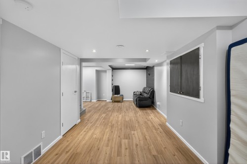 Spacious room featuring light wood flooring, light gray walls, and recessed lighting - 1522 Chapman Way, Edmonton, AB - Indoor Photo Showing Other Room