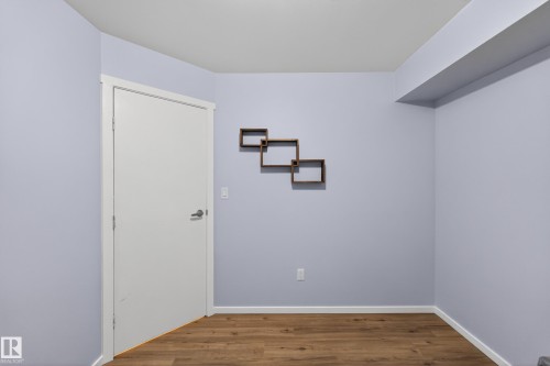 This room features hardwood flooring and light-colored walls, with a white door and trim - 1522 Chapman Way, Edmonton, AB - Indoor Photo Showing Other Room