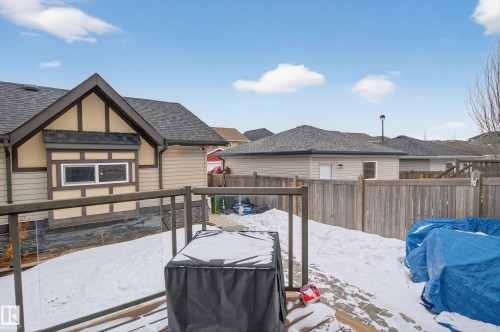 The property features a well-maintained exterior with tan siding and dark trim - 1522 Chapman Way, Edmonton, AB - Outdoor