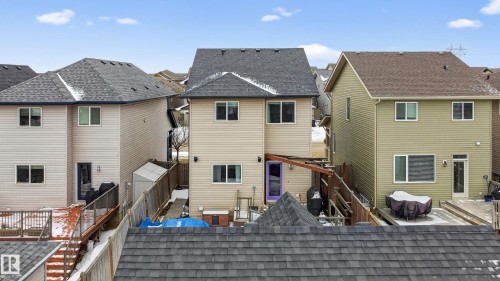 The property features a two-story exterior with light-colored siding, a dark roof, and multiple windows - 1522 Chapman Way, Edmonton, AB - Outdoor With Exterior