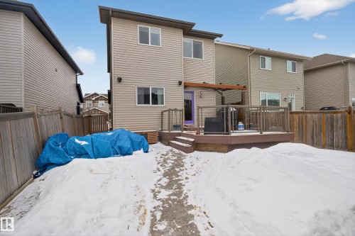 The property features a two-story exterior with light-colored siding and a multi-level deck - 1522 Chapman Way, Edmonton, AB - Outdoor With Exterior