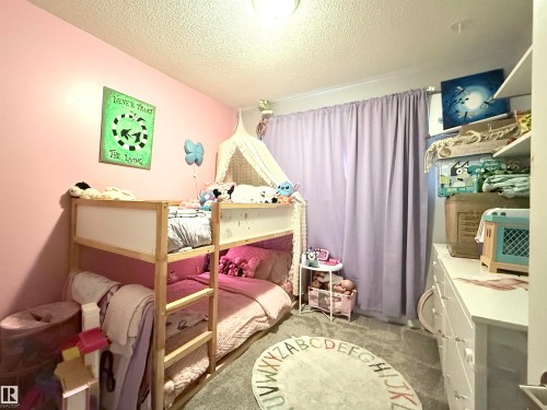 The room features pink walls and a light-colored bunk bed - 3912 108 Street, Edmonton, AB - Indoor Photo Showing Bedroom