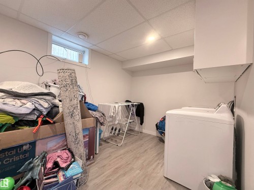 The property features a utility room with light-colored flooring, a window, and a drop ceiling - 3912 108 Street, Edmonton, AB - Indoor