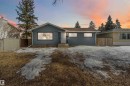 The property features a blue exterior with a light-colored front door and a dark roof - 12121 38 Street, Edmonton, AB  - Outdoor 
