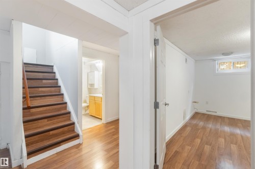 This area features wood-look flooring and white walls - 12121 38 Street, Edmonton, AB - Indoor Photo Showing Other Room