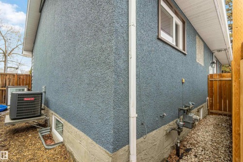 The property features blue stucco siding and visible foundation - 12121 38 Street, Edmonton, AB - 