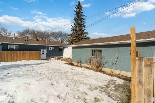 The property features a dark blue exterior with white trim and a brown roof - 12121 38 Street, Edmonton, AB - Outdoor