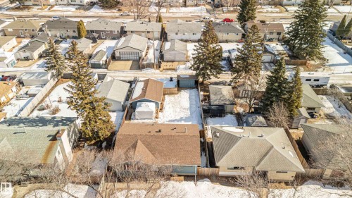 This property features a fenced yard, a detached garage, and mature trees - 12121 38 Street, Edmonton, AB - Outdoor