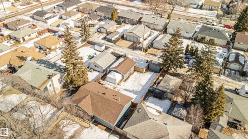 Aerial view of the property and surrounding neighborhood, featuring mature trees and nearby roadways - 12121 38 Street, Edmonton, AB - Outdoor
