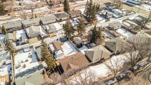 Aerial view of a residential neighborhood with houses featuring various roof styles, including gable and hip roofs - 12121 38 Street, Edmonton, AB - Outdoor
