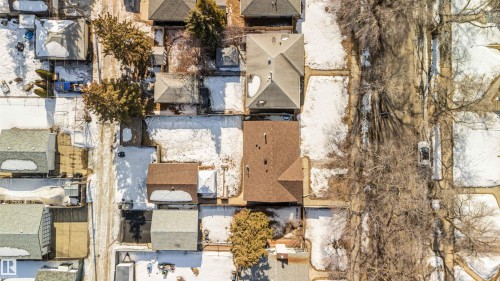 Aerial view of the property and its surrounding neighborhood, featuring residential homes, bare trees, and snow-covered ground - 12121 38 Street, Edmonton, AB - Outdoor