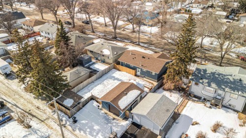 Aerial view showcasing the property with a brown-roofed garage and a fenced yard - 12121 38 Street, Edmonton, AB - Outdoor
