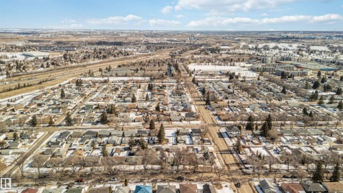 Aerial view of the surrounding area featuring residential streets and properties with visible rooftops and some mature trees - 12121 38 Street, Edmonton, AB - Outdoor With View