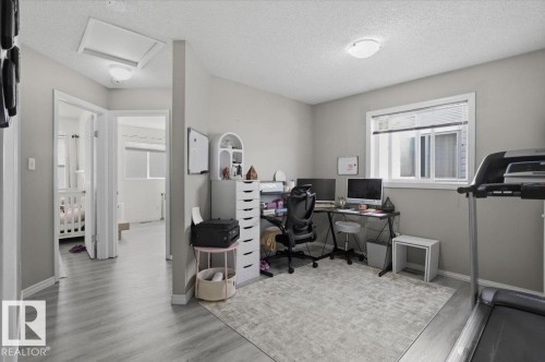 This versatile room features light-colored walls, a window with blinds, and light-toned flooring, offering a neutral canvas for various uses - 5837 162A Avenue, Edmonton, AB - Indoor