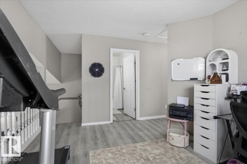 This versatile room features light grey walls, light-colored flooring, and a white interior door - 5837 162A Avenue, Edmonton, AB - Indoor
