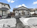 This property features a front entrance with a small porch and steps, a bay window, and light-colored siding - 5837 162A Avenue, Edmonton, AB  - Outdoor With Facade 