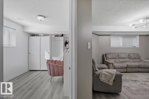 The property features light gray flooring in both visible areas - 5837 162A Avenue, Edmonton, AB - Indoor